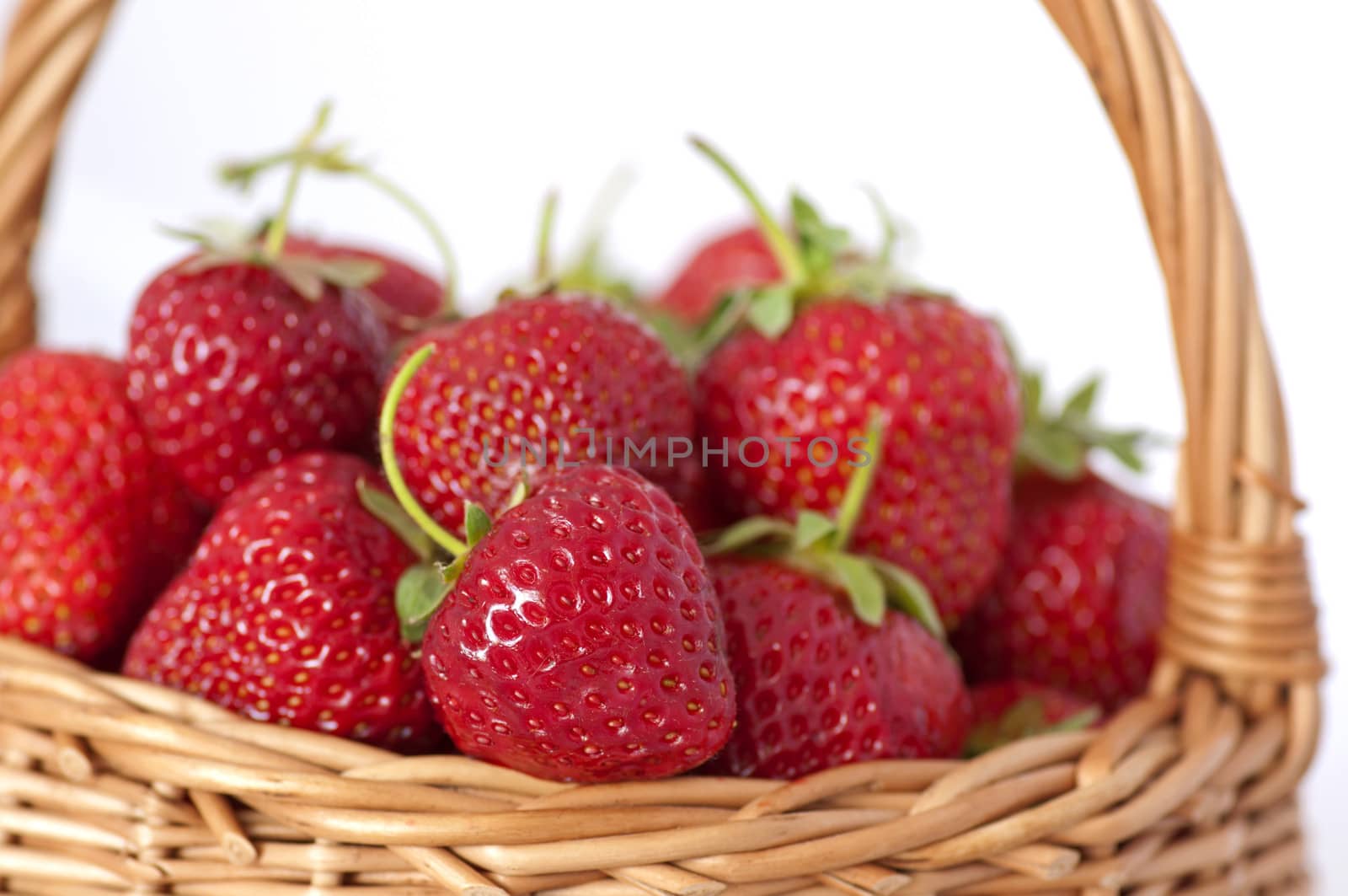 Organic strawberries in basket on white background by dred