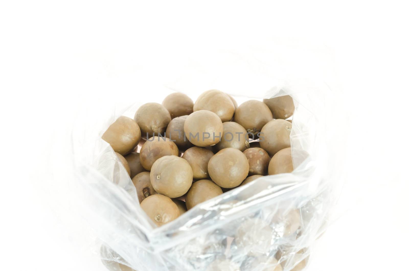 macadamia in plastic bag on white background