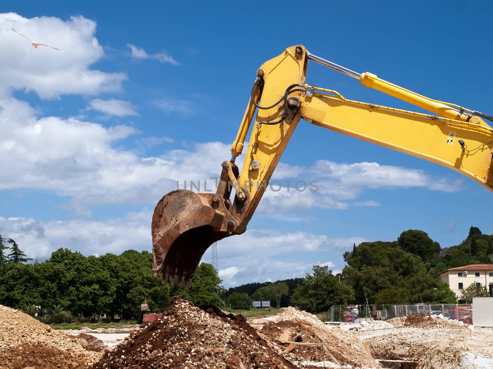 yellow excavator working on building site