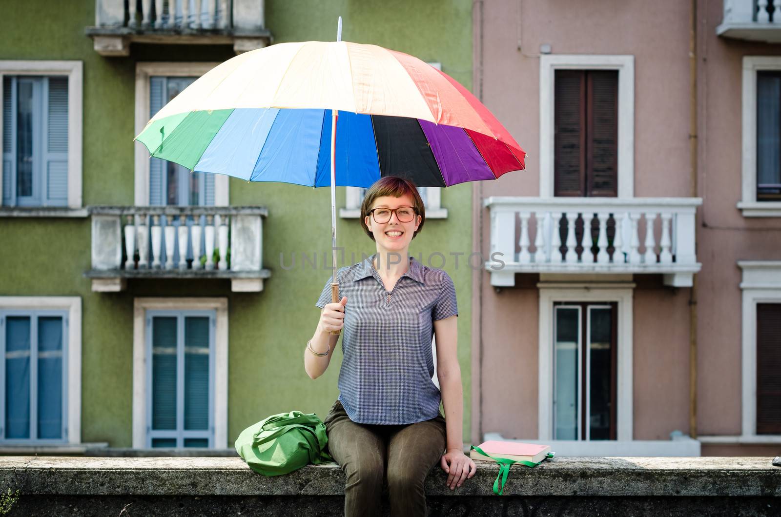 young beautiful hipster woman with colorful umbrella in the city