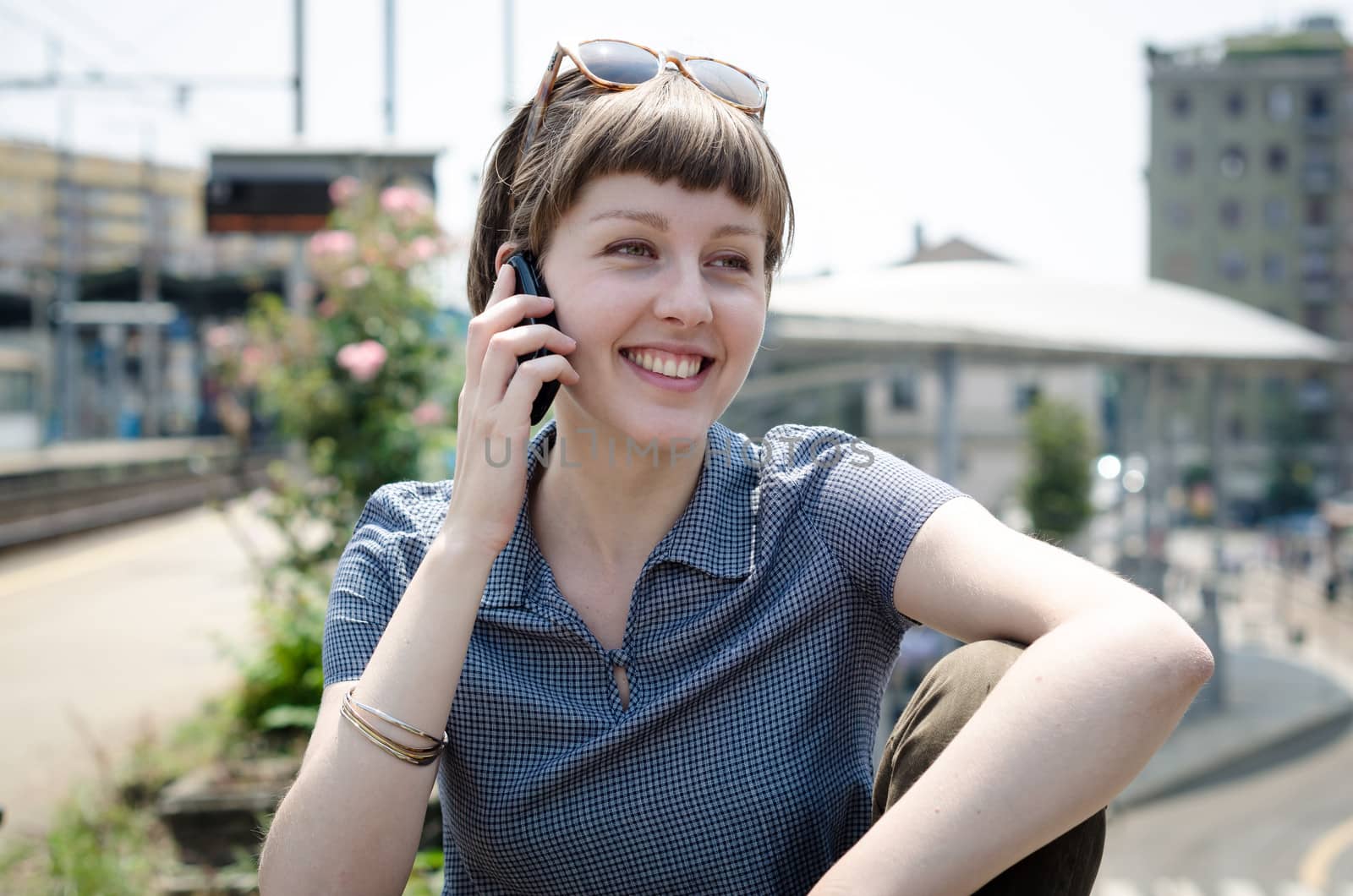 young beautiful hipster woman on the phone in the city