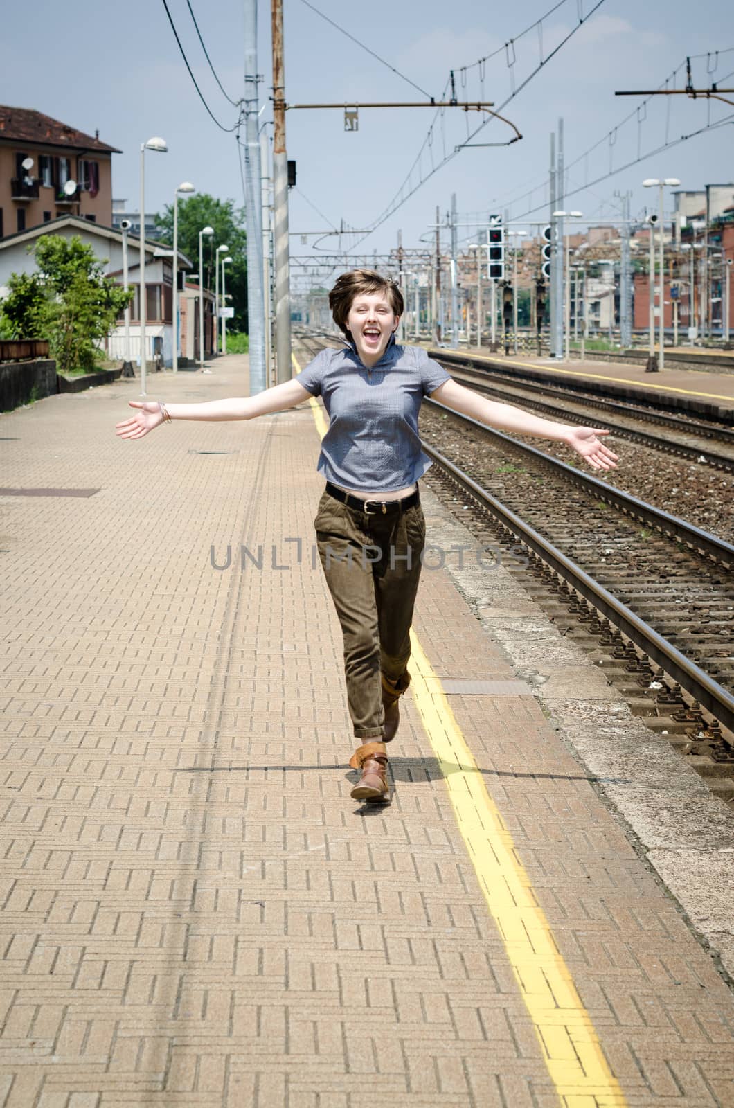 young beautiful hipster woman happy running in the station