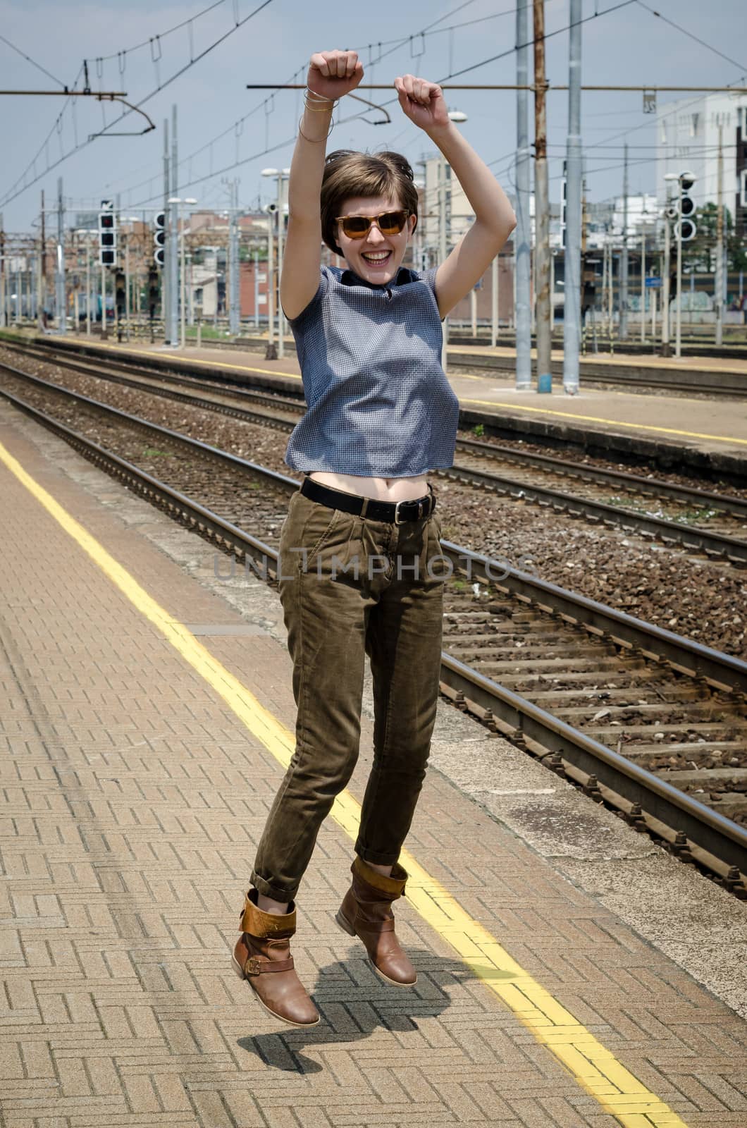 young beautiful hipster woman jumping in the station