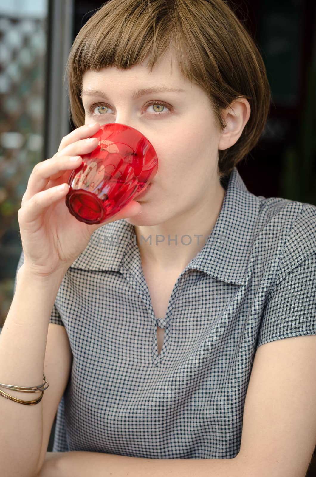 young beautiful hipster woman drinking at the bar