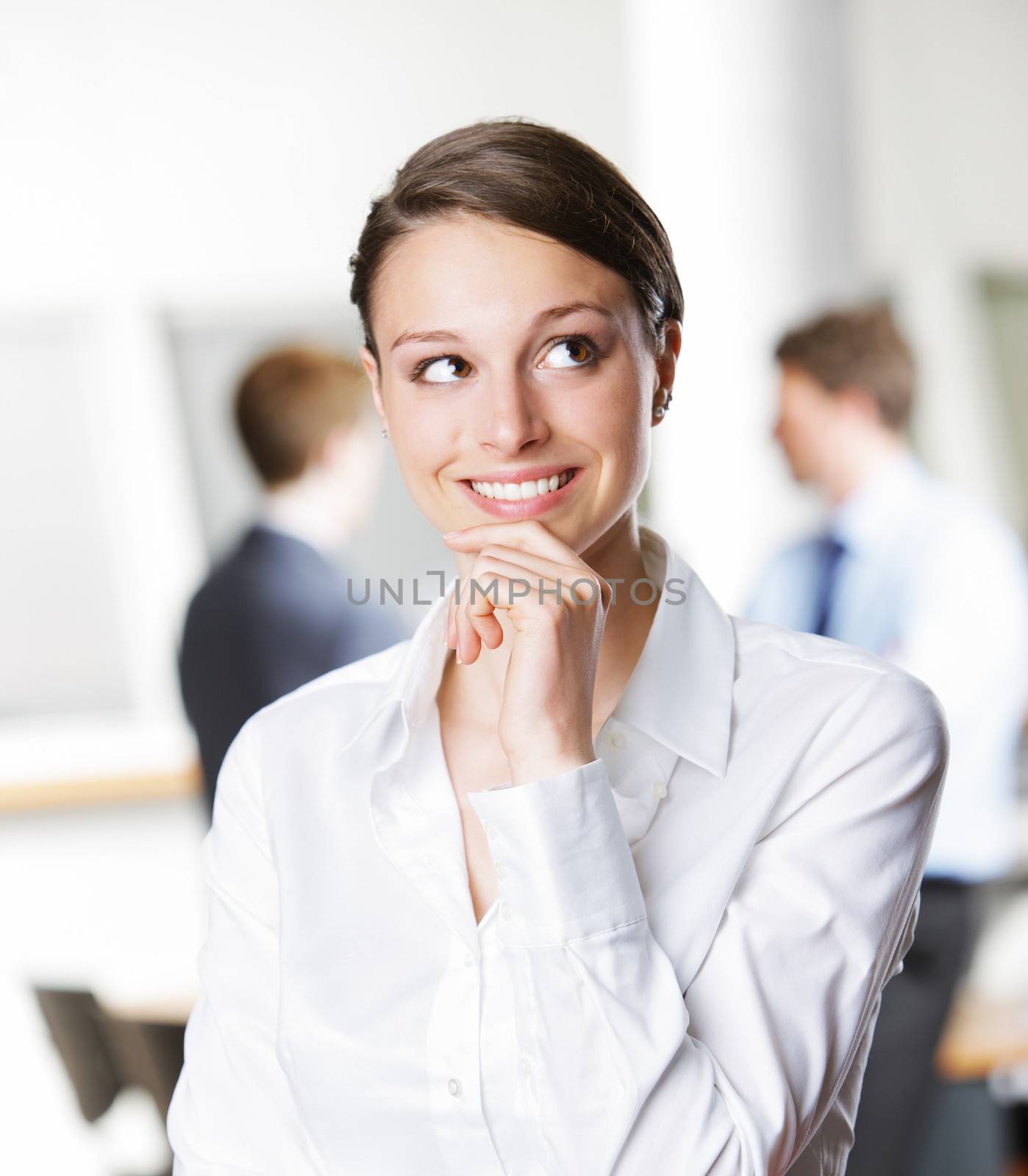 Beautiful young businesswoman thinking, looking up