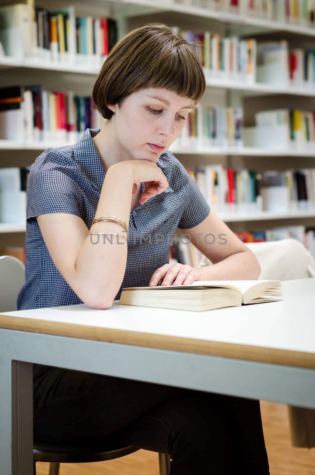 young beautiful hipster woman in library