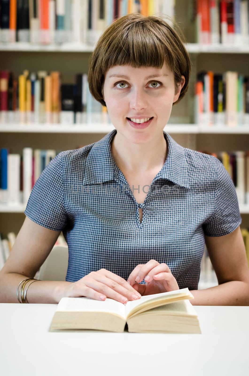 young beautiful hipster woman in library