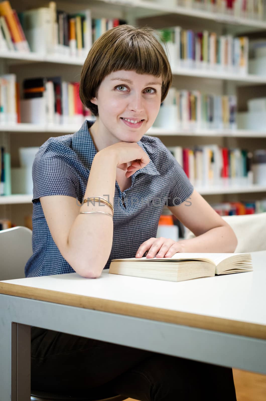 young beautiful hipster woman in library