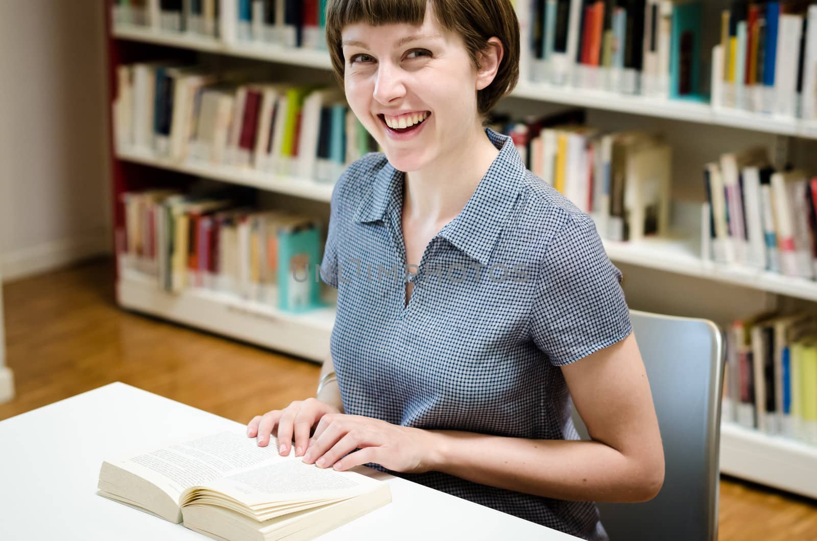 young beautiful hipster woman in library