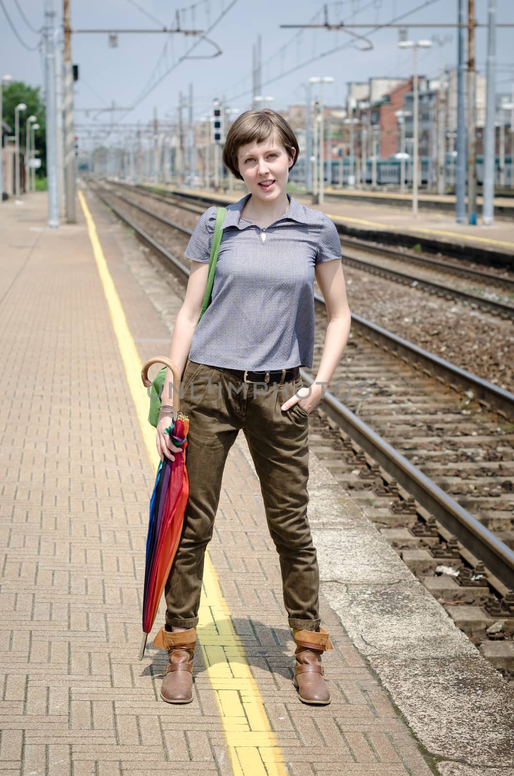young beautiful hipster woman in railway station