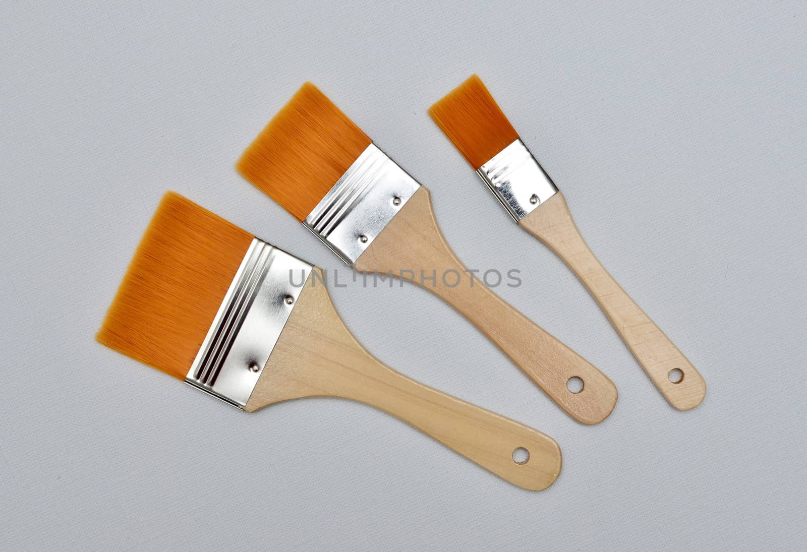 new paint brushes on canvas background by DNKSTUDIO