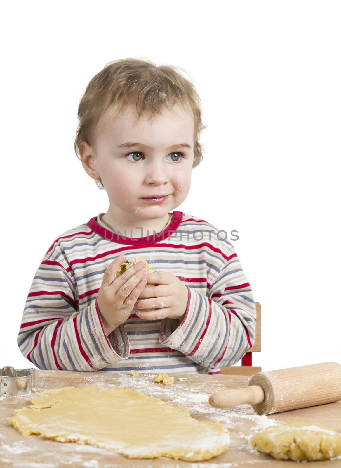 cute child with dough and rolling pin isolated on white background. horizontal image