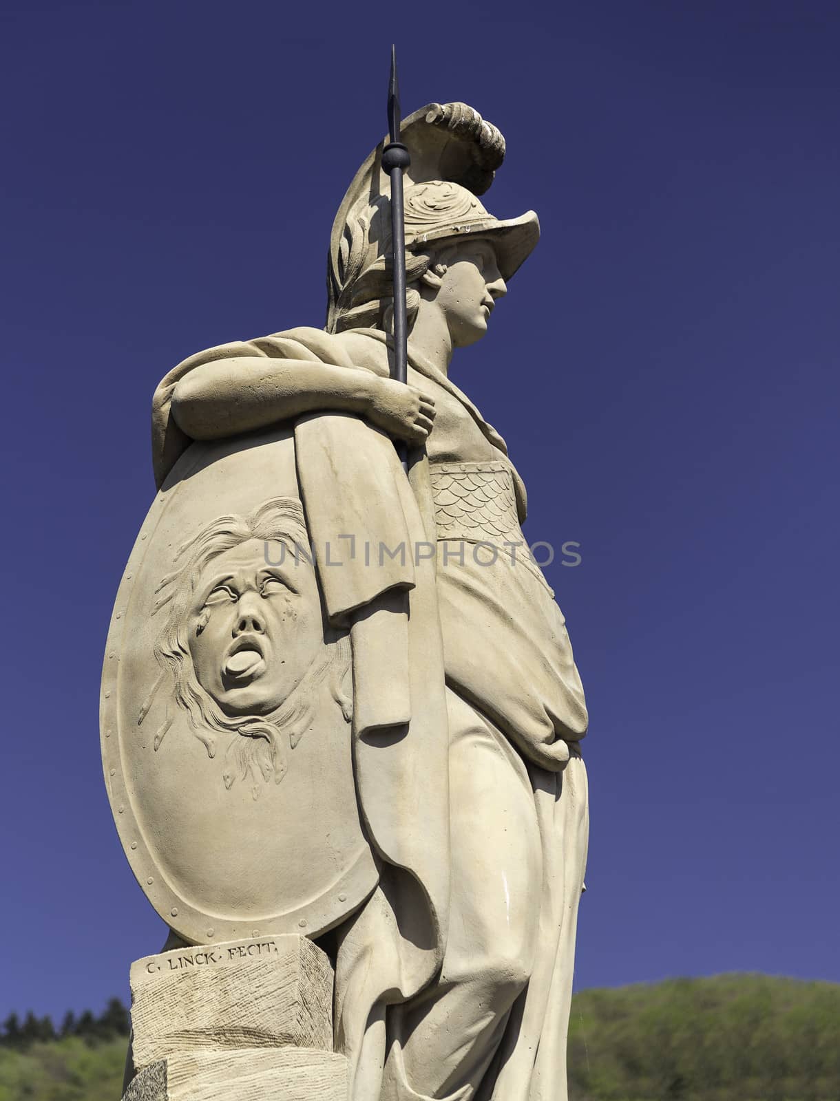 Statue of Minerva from 1790 goddess wisdom on old bridge leading to ancient town city of Heidelberg Germany