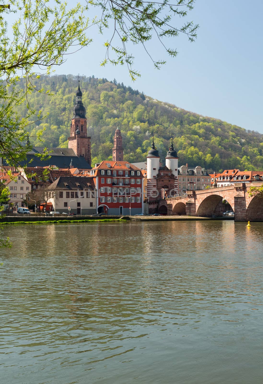 Medieval bridge leading into old town of Heidelberg Germany from riverbank of River Neckar