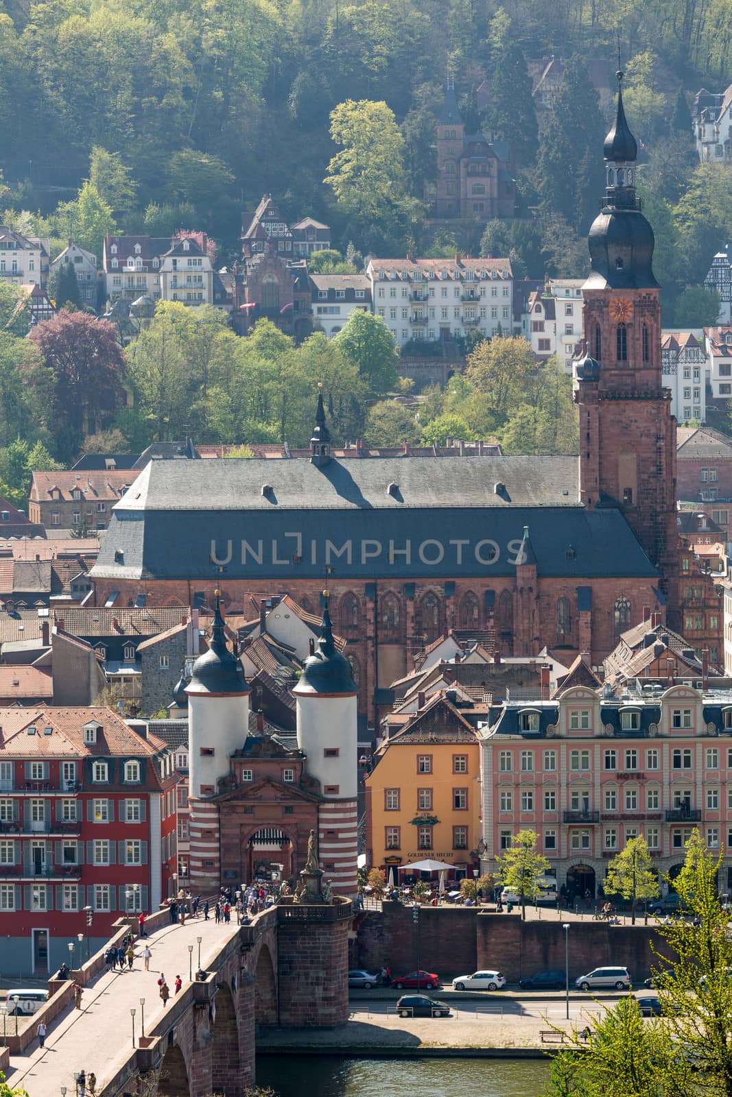 HEIDELBERG, GERMANY - APRIL 25: Tourists and locals stroll through gateway into old town on 25 April 2013. The bridge was built in 1786