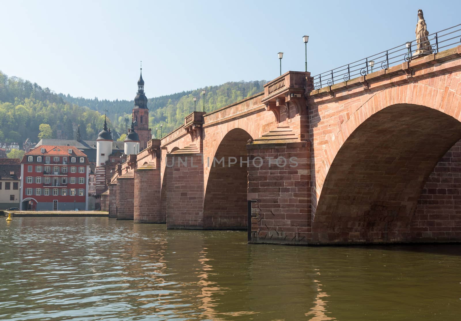 Medieval bridge leading into old town of Heidelberg Germany from riverbank of River Neckar