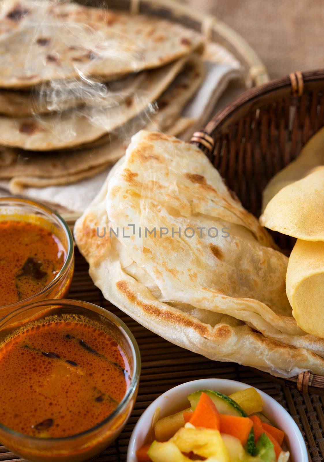 Indian meal, Chapati flatbread, roti canai, dal, curry, teh tarik or pulled tea, acar. Famous indian food.