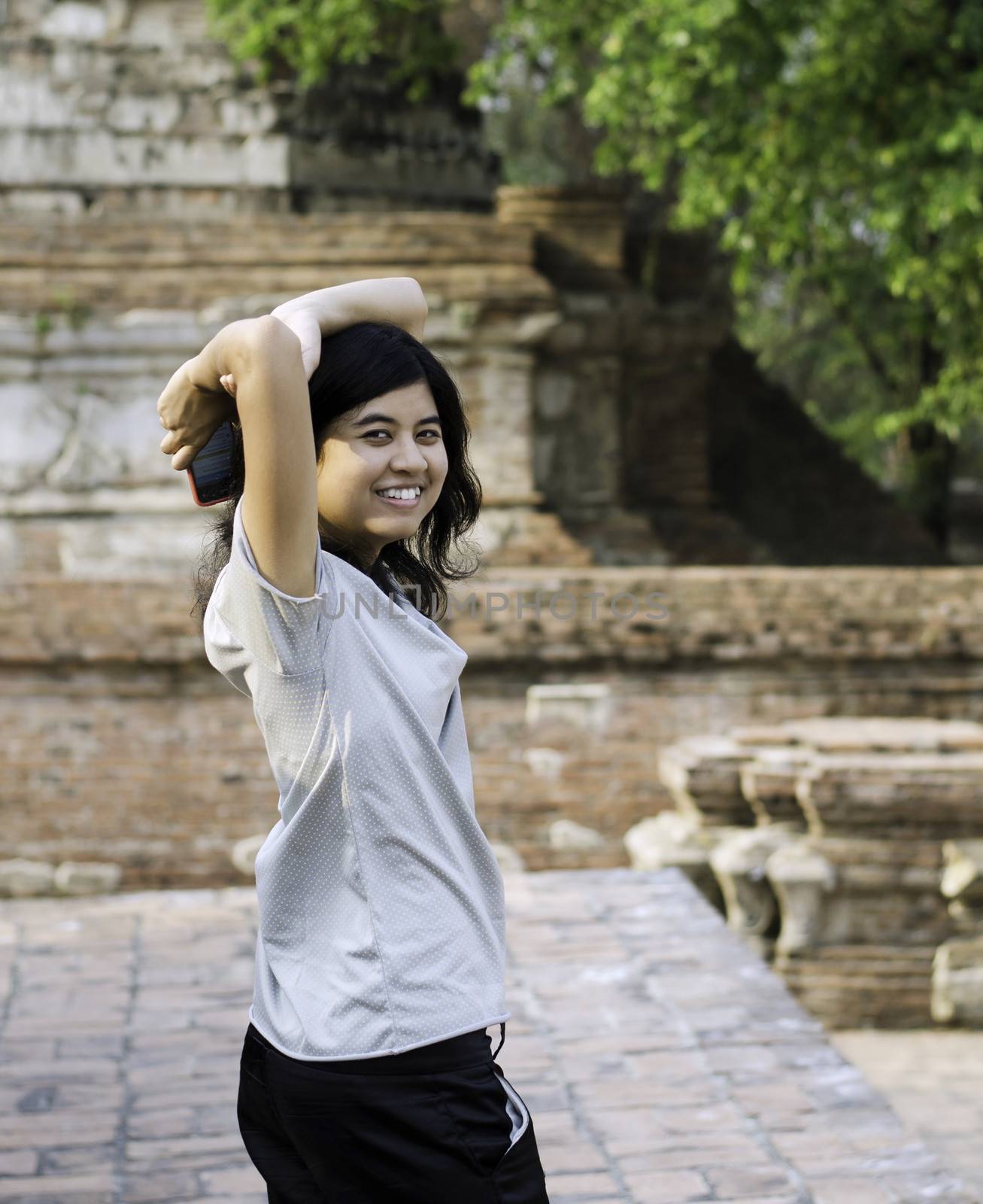 Asian woman enjoying at Wat Maheyong Temple. Ayutthaya province - Thailand 