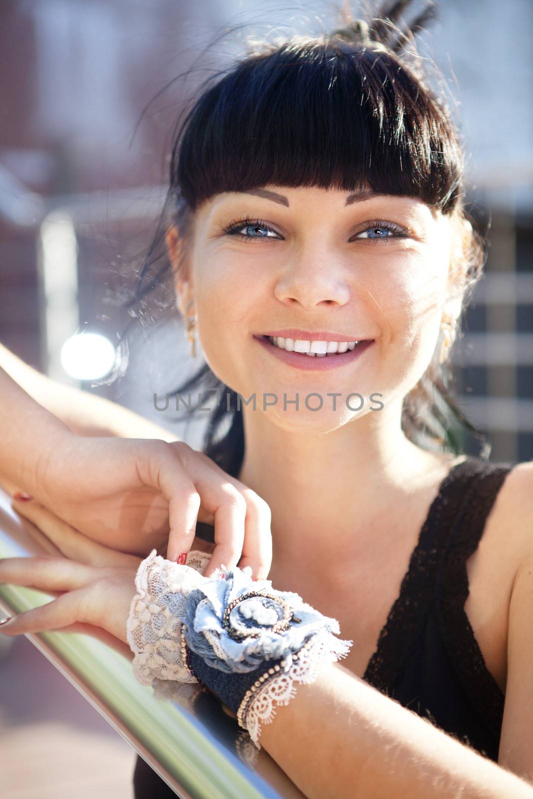 face of beautiful young woman in black blouse by ssuaphoto