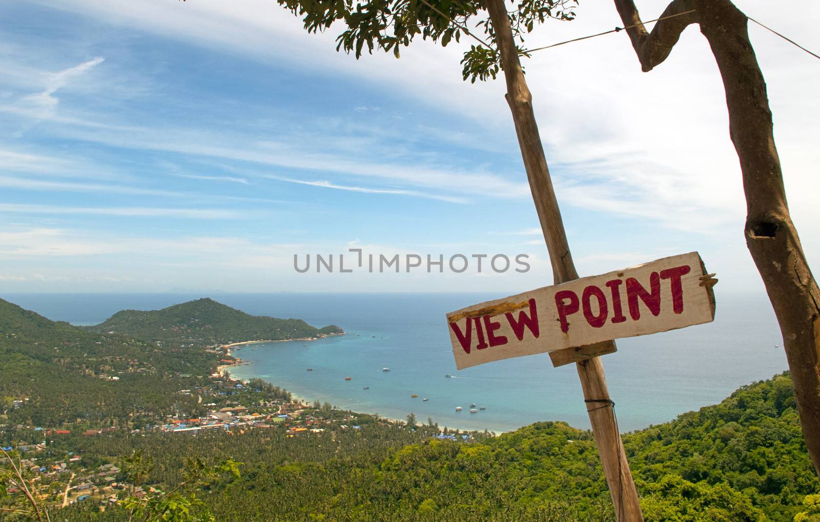 View from the hillside of a tropical island with a sign saying view point