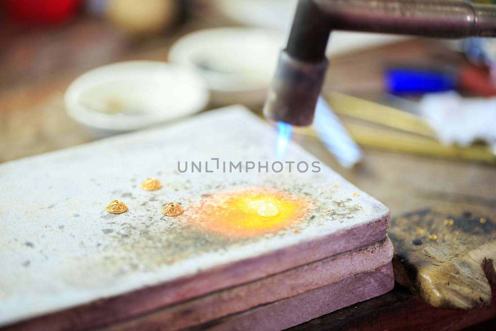 Goldsmith working with a thai traditional bracelet