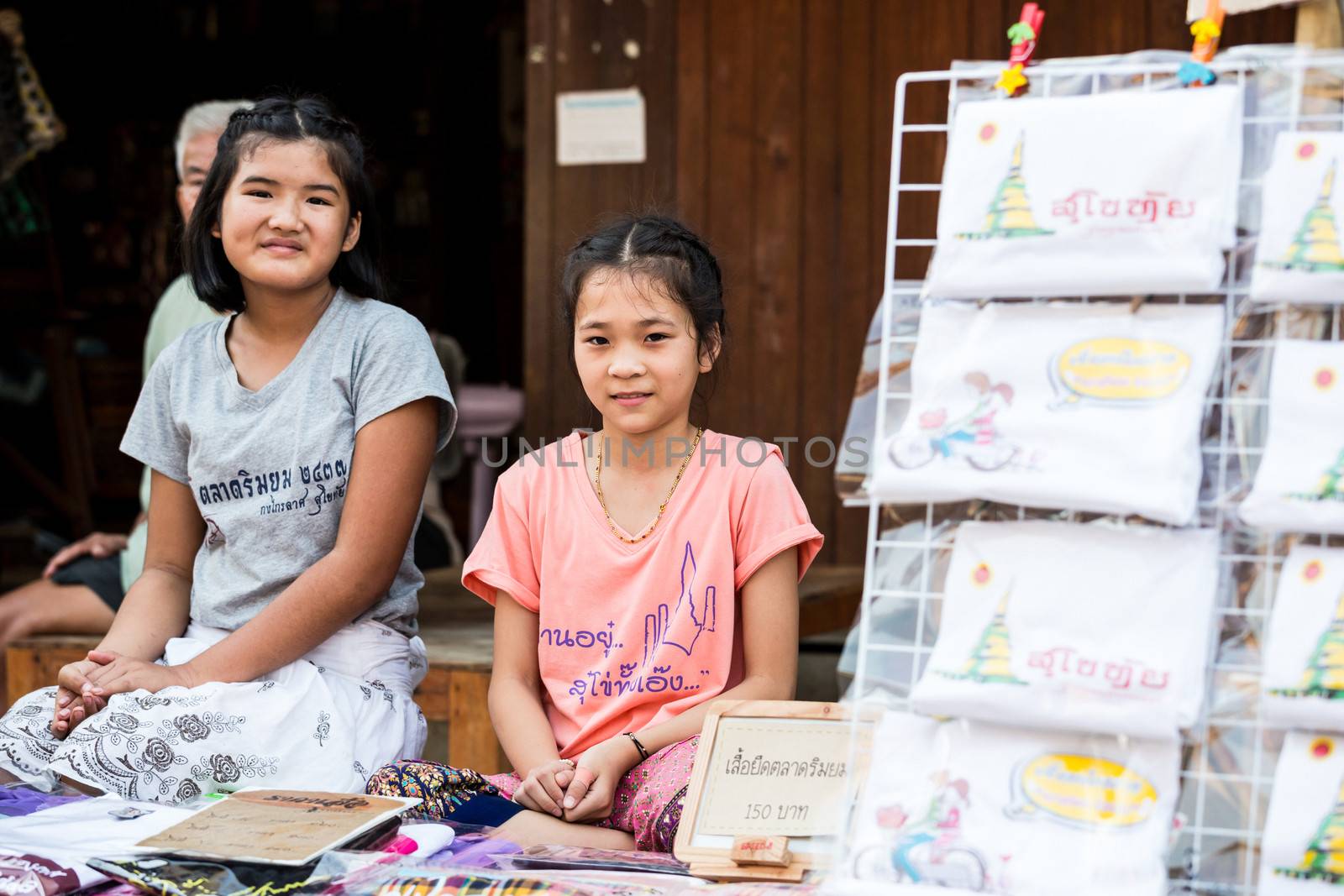 SUKHOTHAI, THAILAND - MAY 4: Unidentified girls are selling Thai traditional souvenir on May 4, 2013 at Rim Yom 2437 night market, Sukhothai, Thailand.