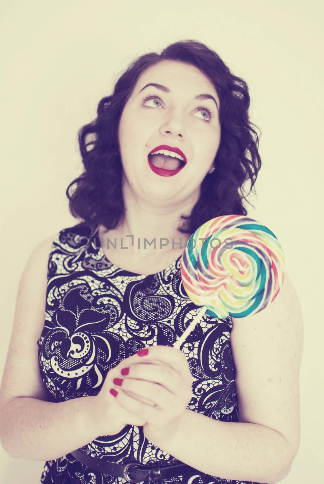 beautiful retro girls portrait with colorful lollipop