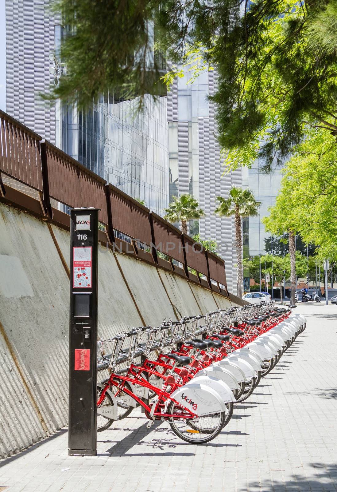 BARCELONA, SPAIN - MAY 30 Public red bicycles parked in a row on the street, in Barcelona, Spain, on May 30, 2013