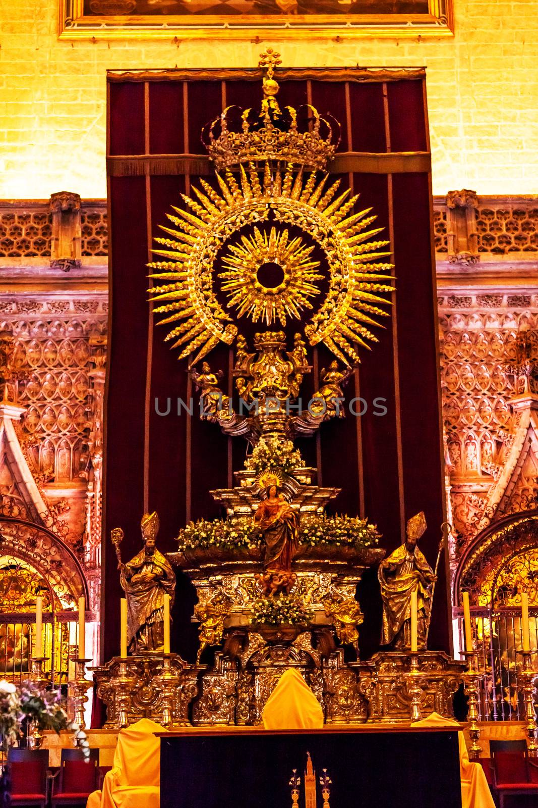 Golden Paseo Madonna Statue Seville Cathedral, Cathedral of Saint Mary of the See, Seville, Andalusia Spain.  During Holy Week, Paseos are paraded around Seville, Spain on Wooden Floats in the Semana de Santa de Sevilla.  This is the Paseo for Seville, Cathedral.