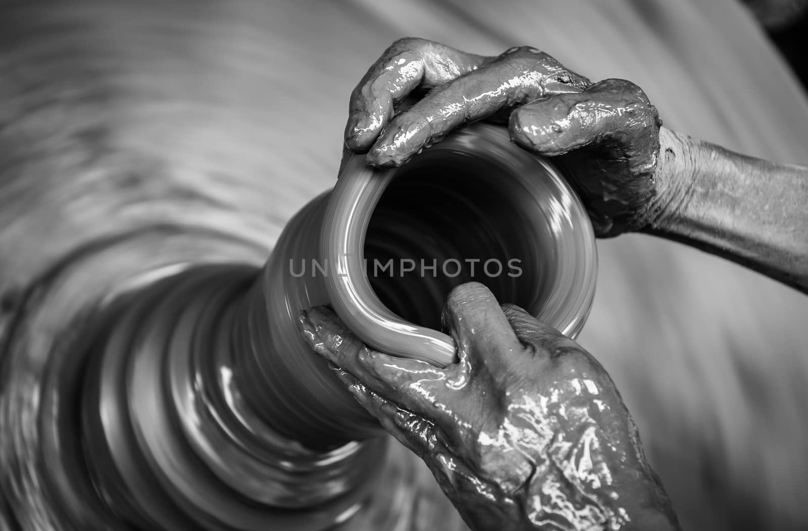 Man's hands creating pottery on wheel by martinm303