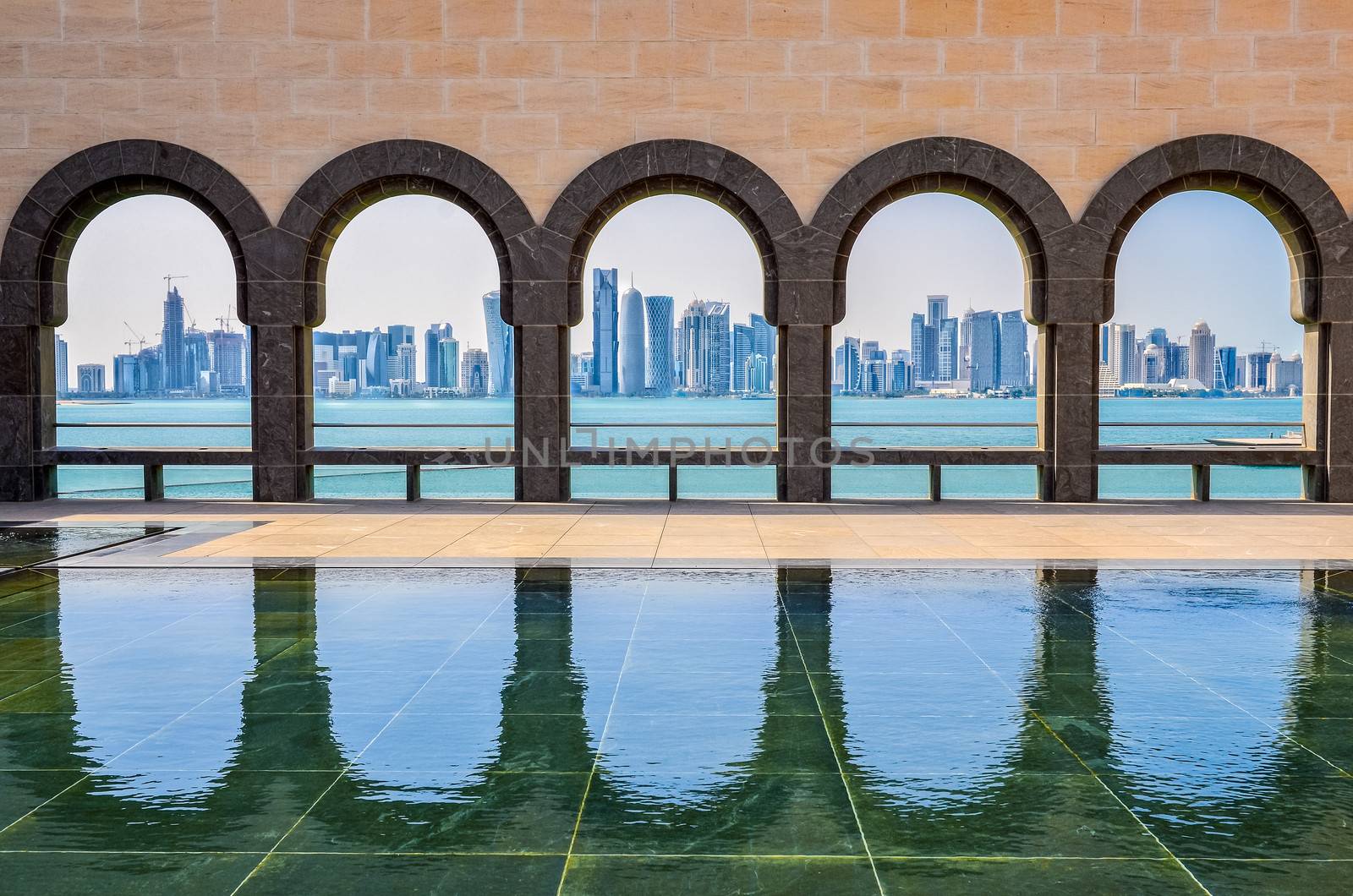 Doha skyline seen through the arches at the Museum of Islamic art, Doha, Qatar