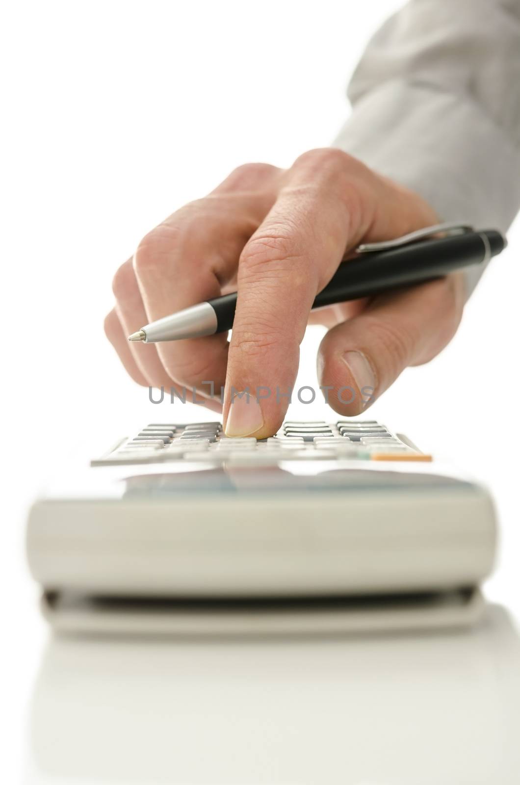 Closeup of male hand using calculator.