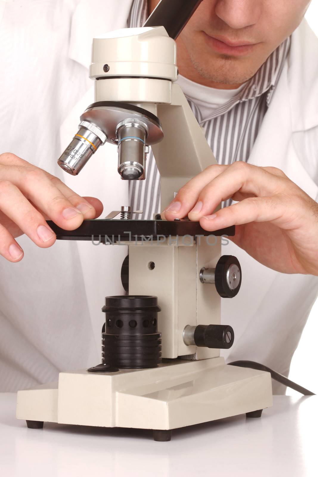 Scientist At Work Using a Microscope on White