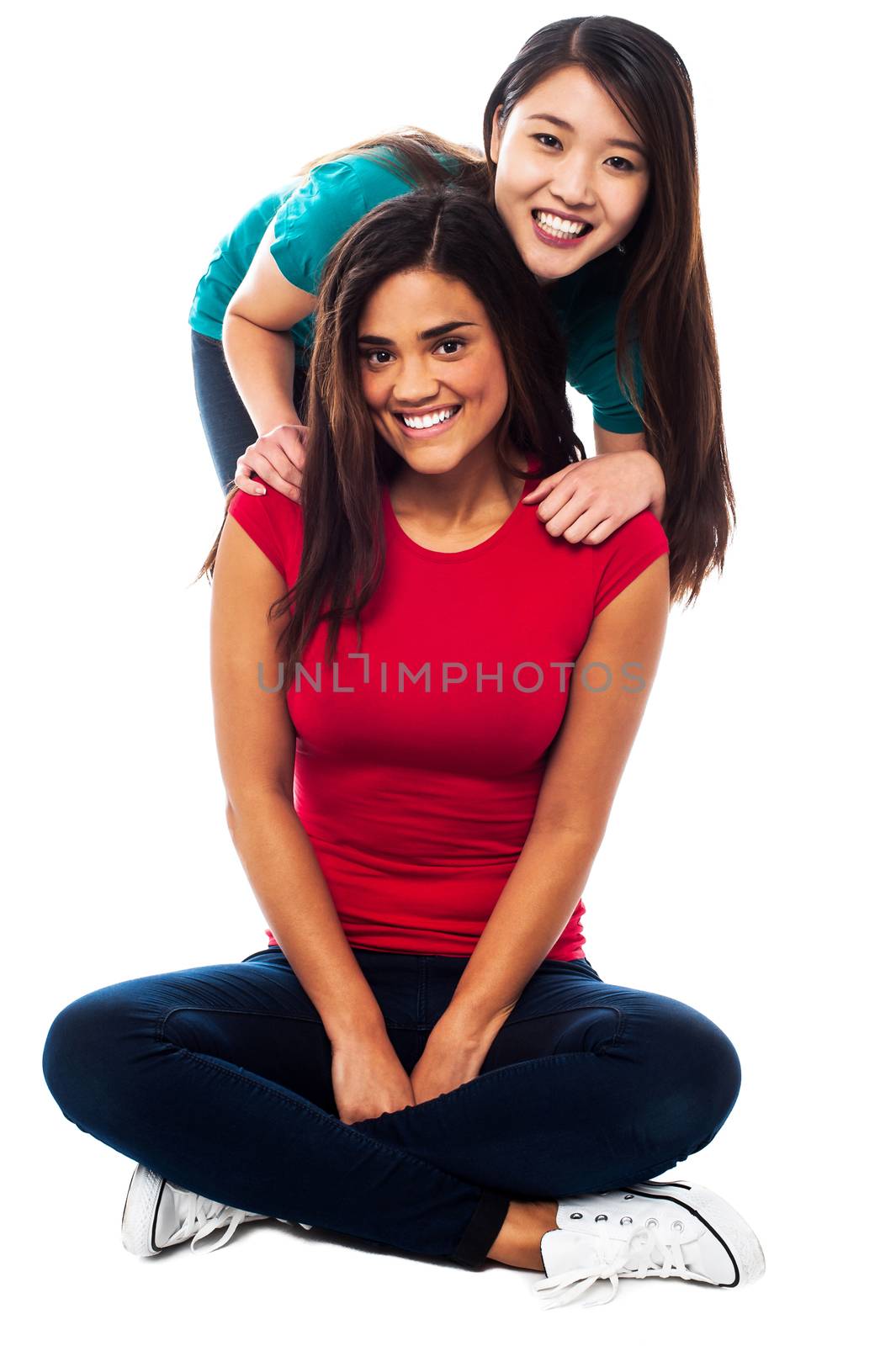 Two young girls posing to camera with a big smile