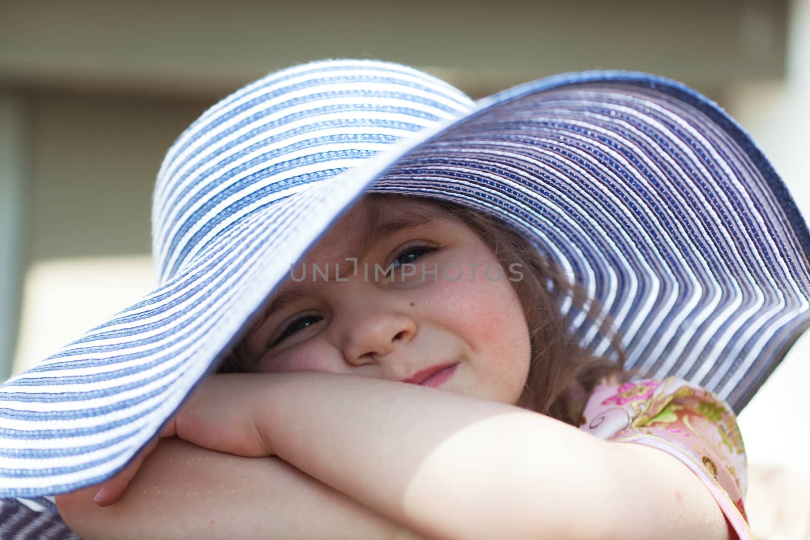 little girl in a big summer hat