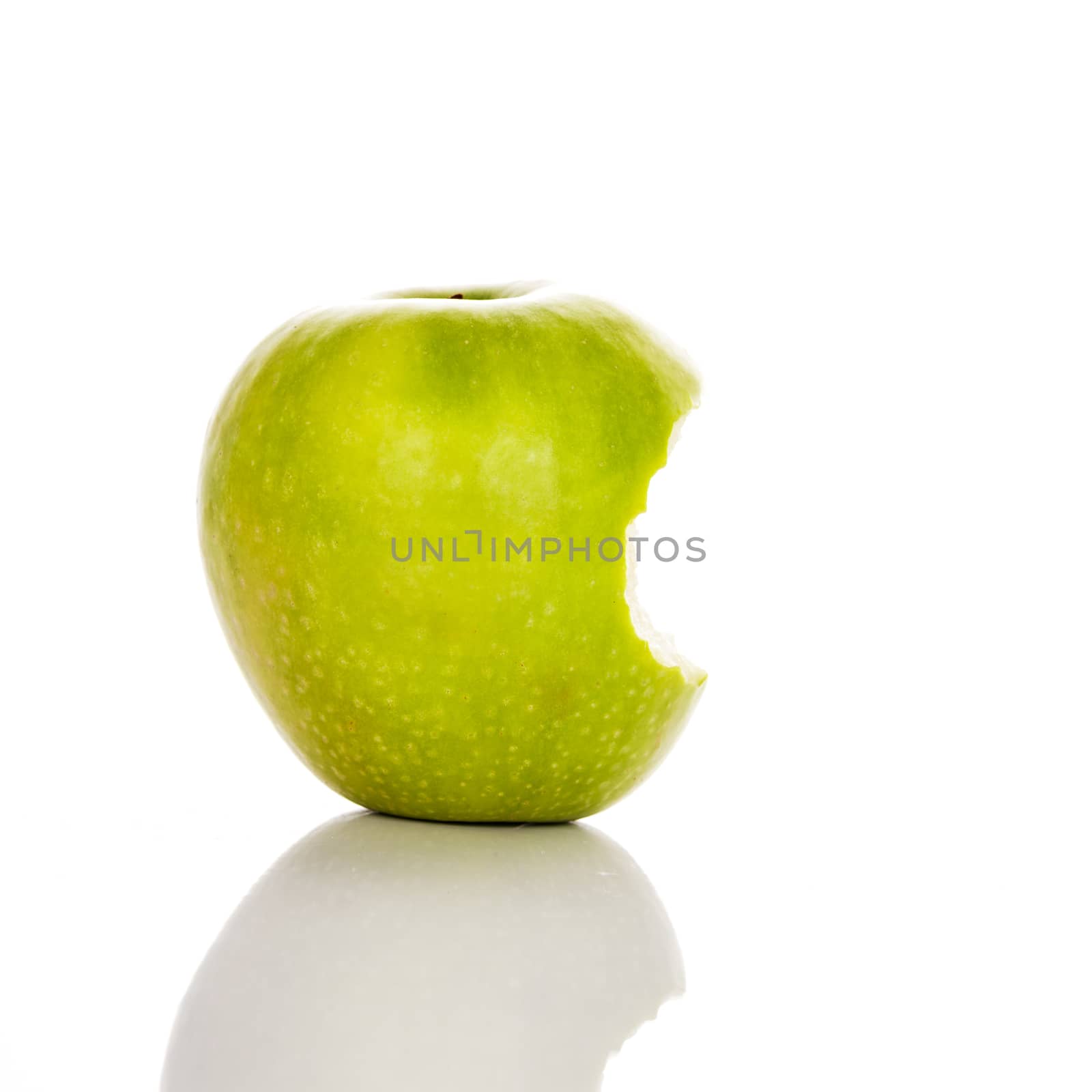 image of bitten green apple on a white background 