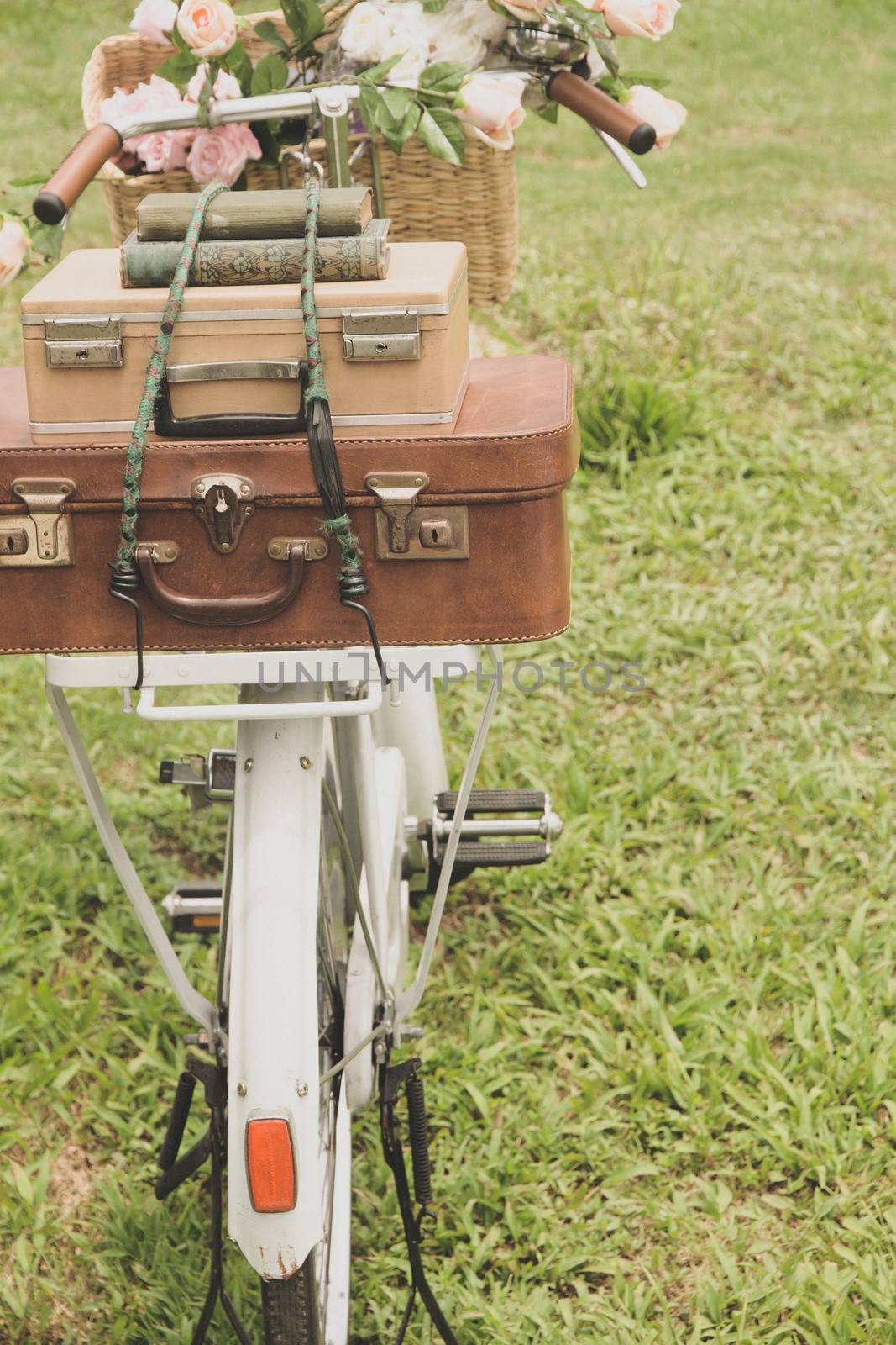 Vintage bicycle on the field with a bag