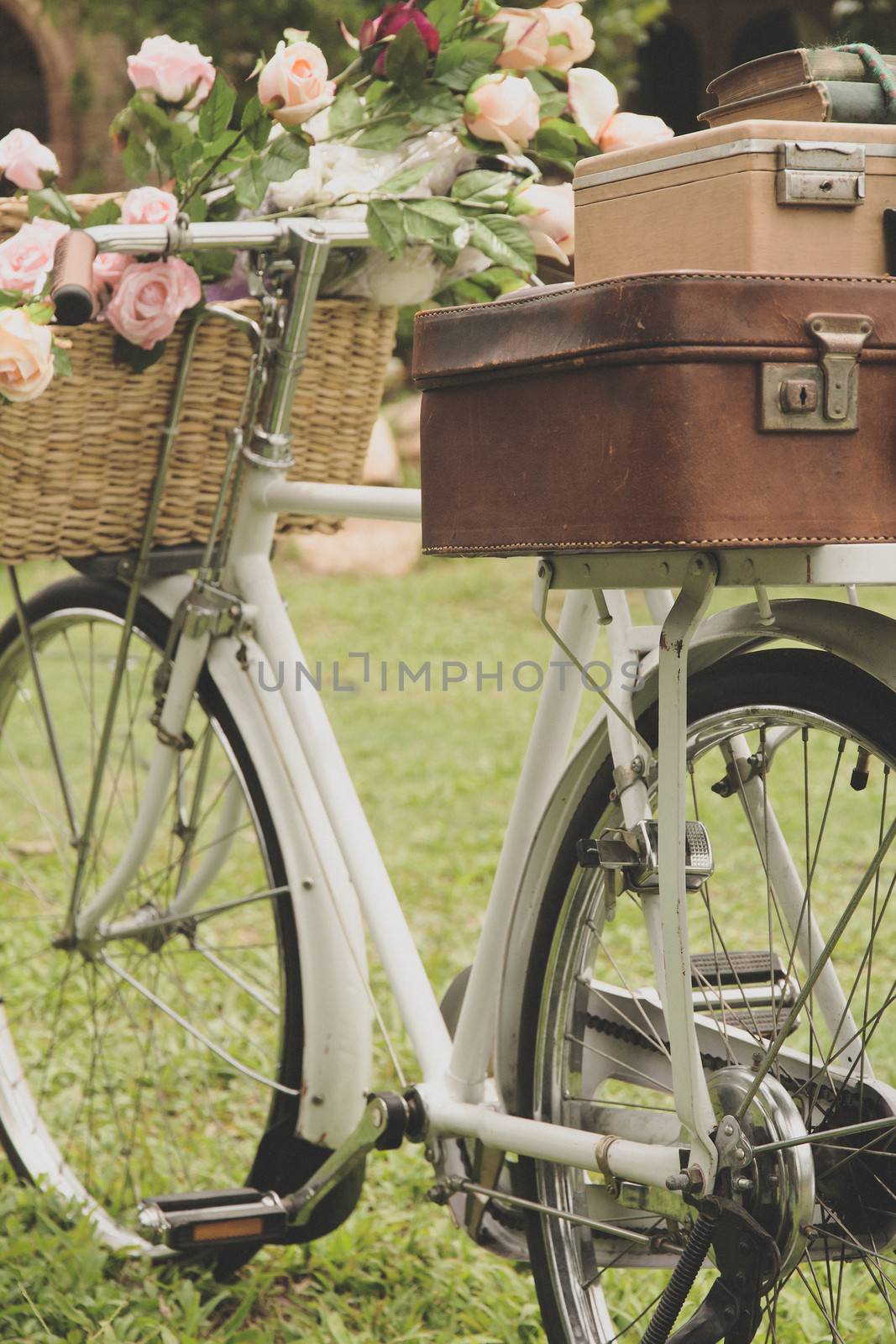 Vintage bicycle on the field with a bag and basket