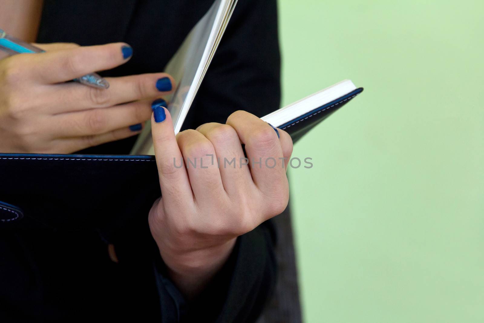 Businesswoman writing in notebook.