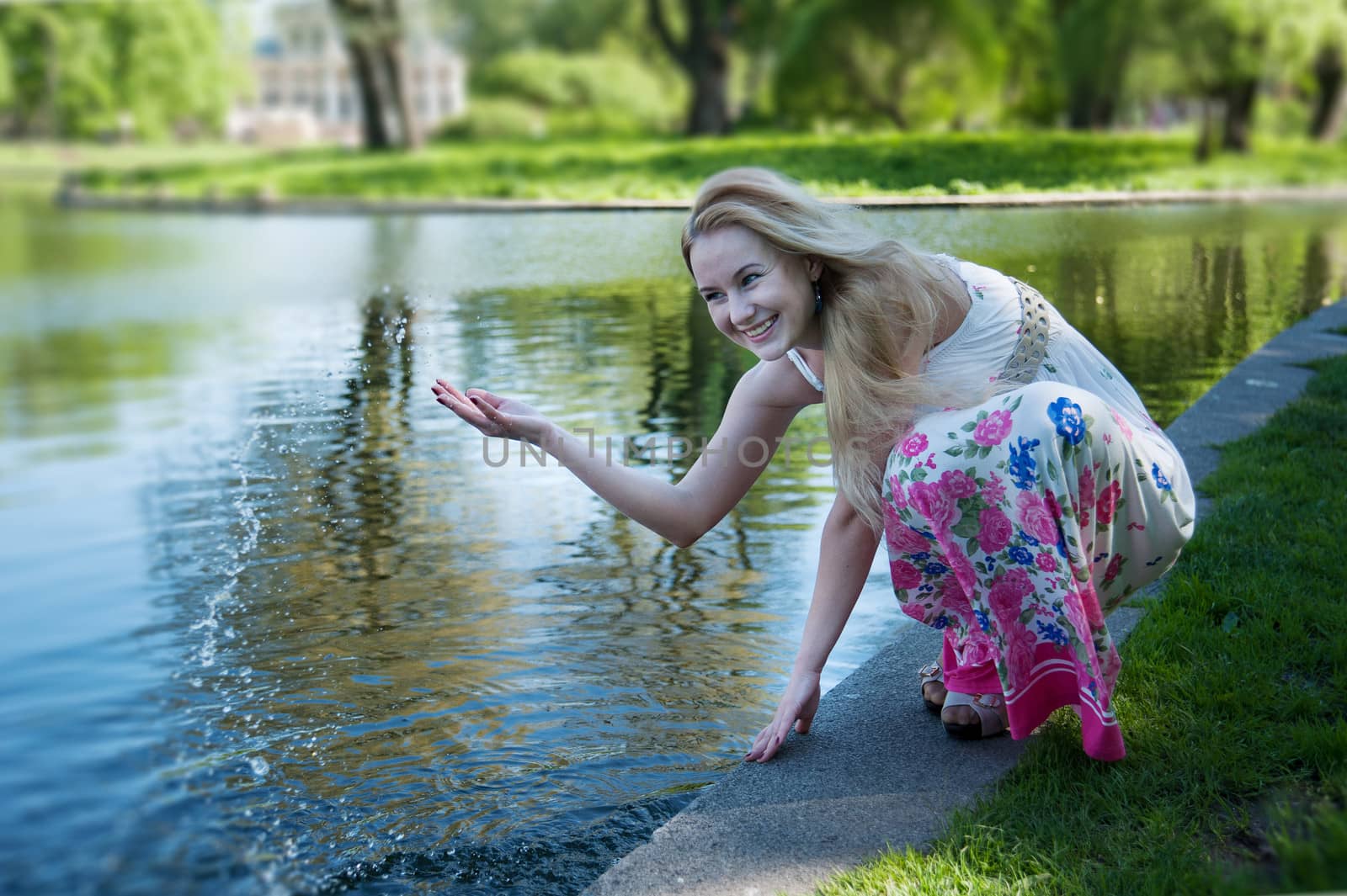 beautiful blonde squirts water in the park