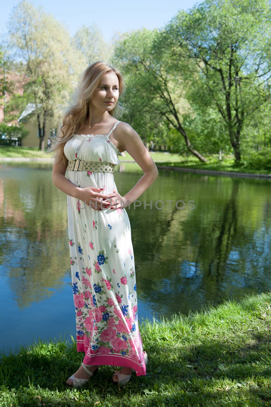 beautiful blonde near the water in the summer park