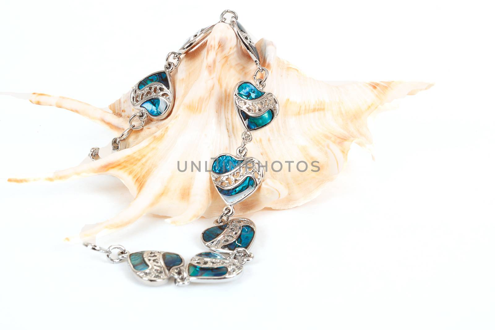 female bracelet with hearts and sea shell isolated on white 