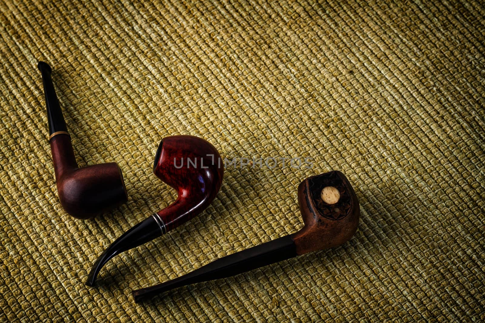 Three vintage smoking pipe on the burlap by dedron