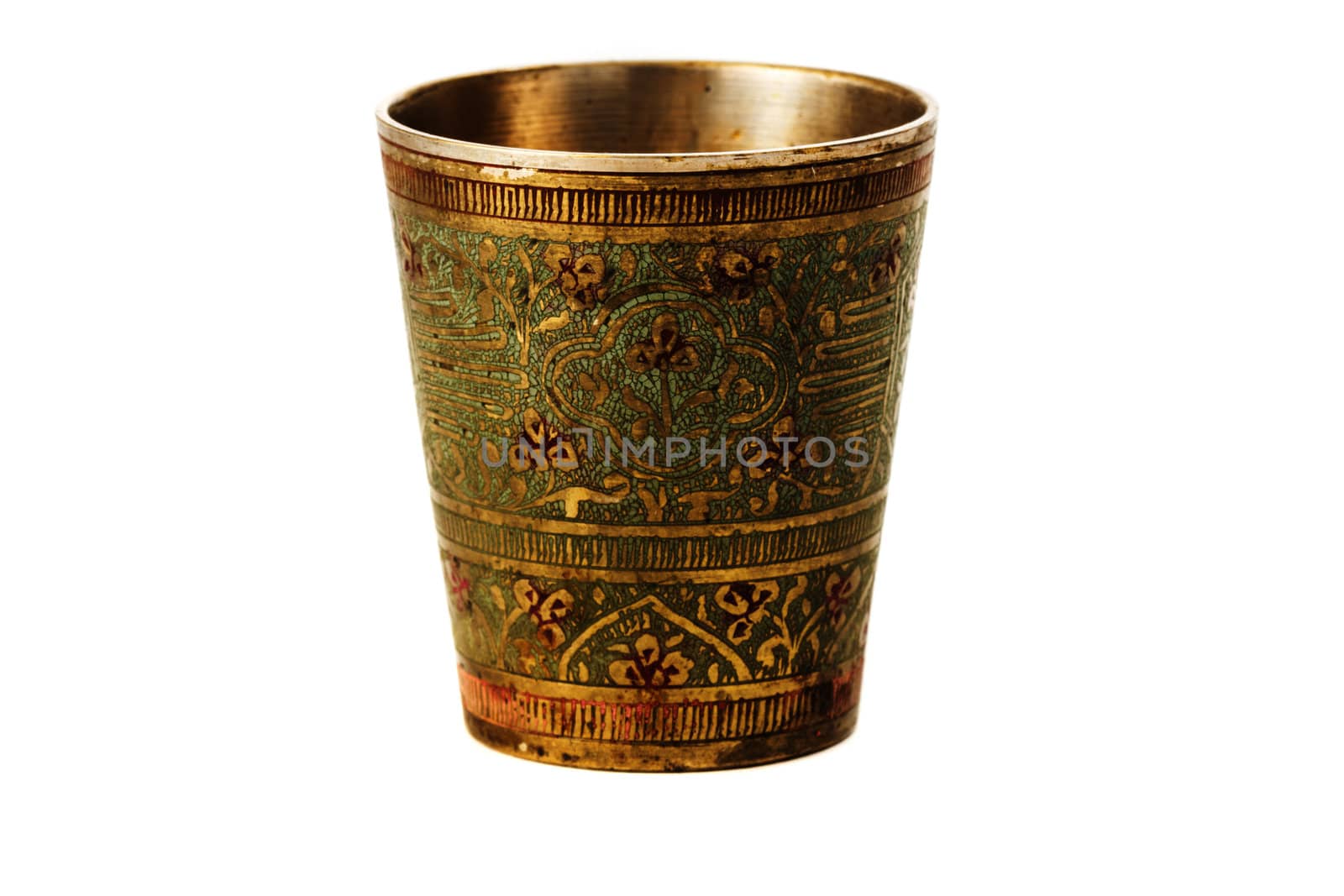 Bronze yellow cup with ornament on a white background