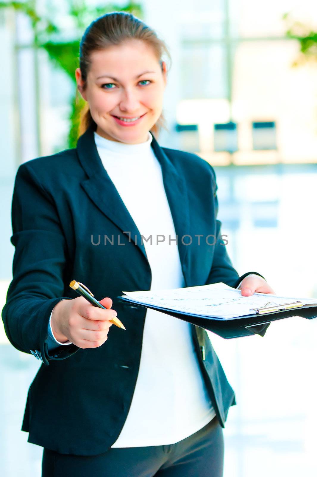 Smiling business woman offers to sign the document