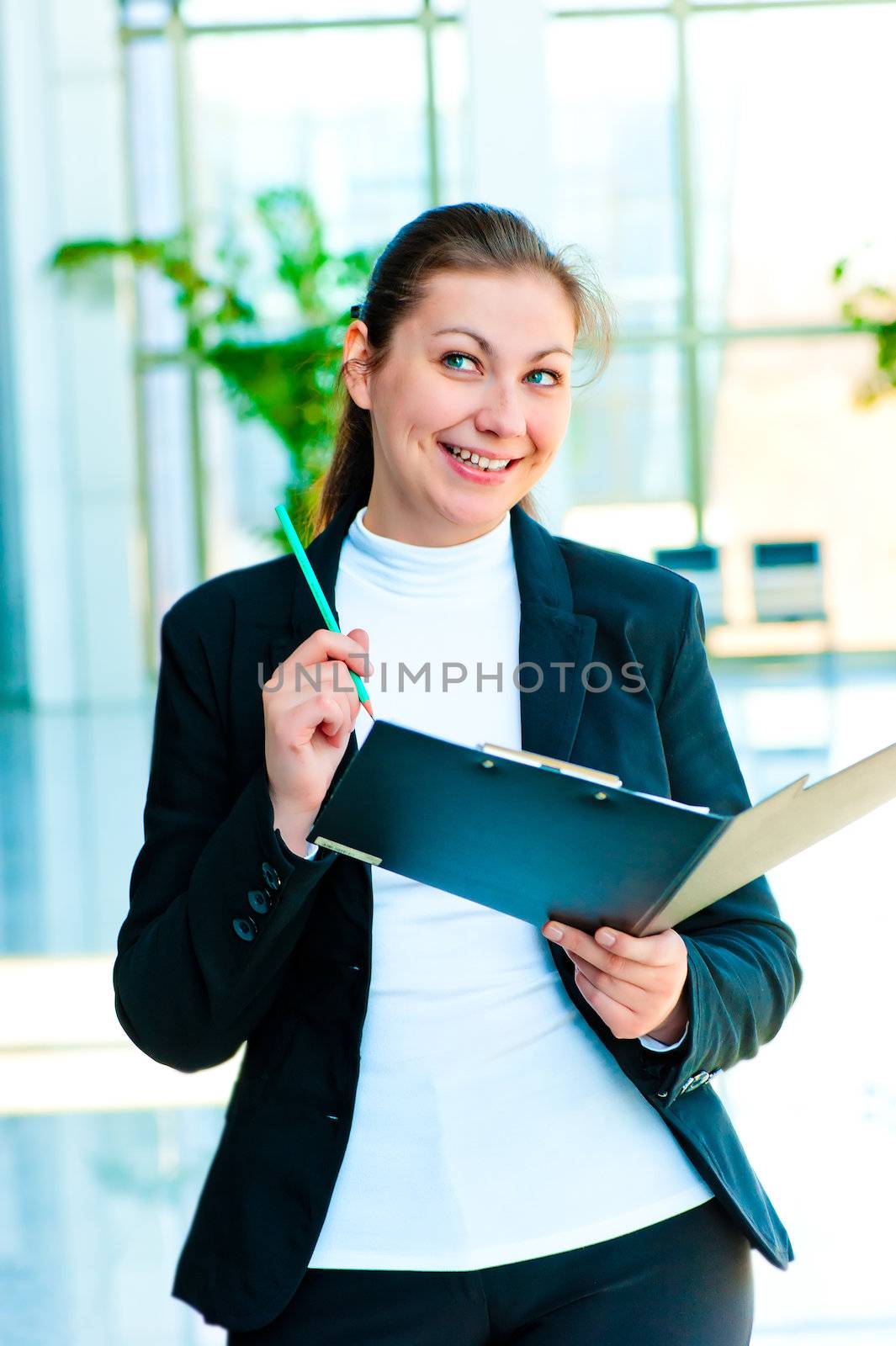 Young happy business woman with an open folder in hand