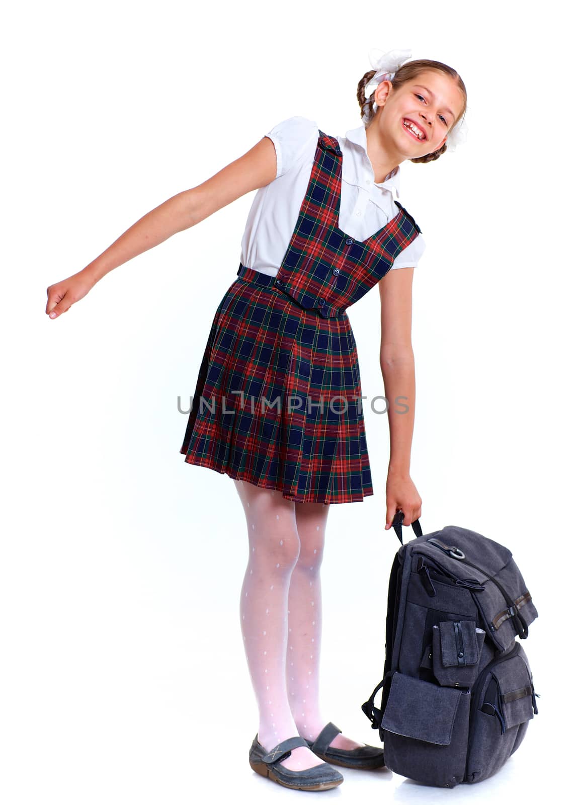 Education theme. Joyful schoolgirl smiling happily with heavy backpack. Isolated on white background