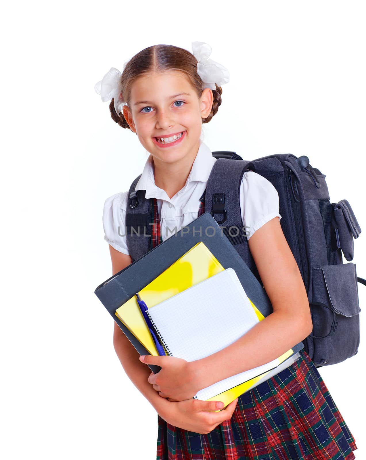 Education theme. Joyful schoolgirl smiling happily with backpack holding book. Isolated on white background