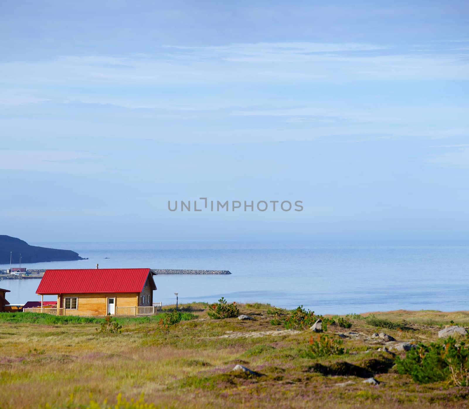 Beautiful house in Iceland. Mountains in background. Panorama