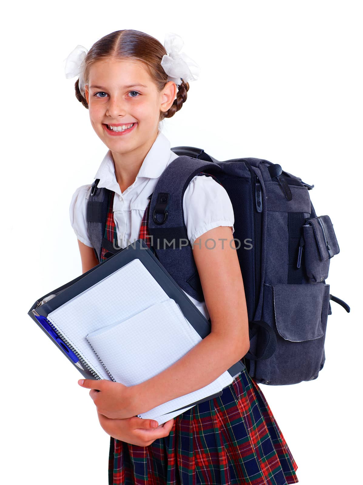 Education theme. Joyful schoolgirl smiling happily with backpack and book. Isolated on white background
